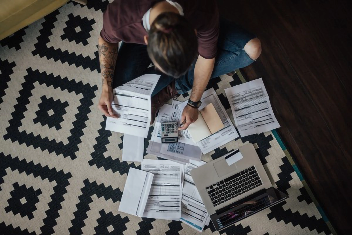 Image of a person looking through bills