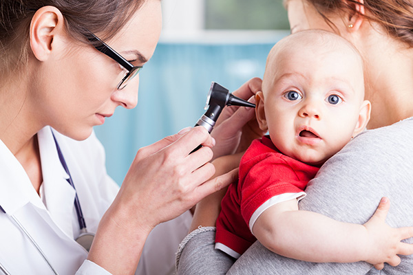 Image of a doctor examining a baby